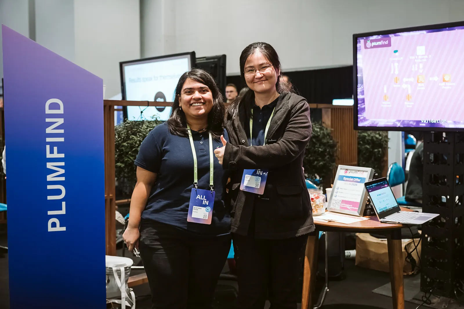 Two Plumfind team members at the company booth in 2025.